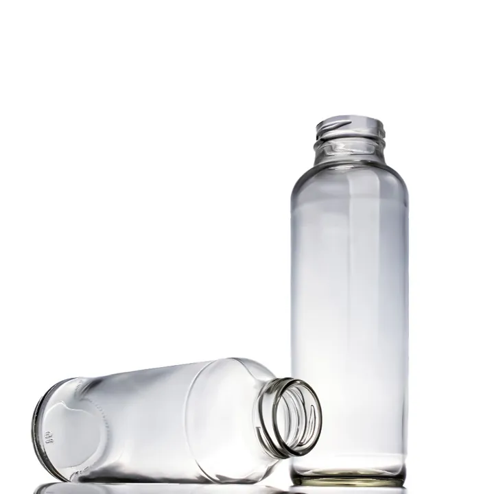 Two clear narrow-neck glass beverage bottles displayed together