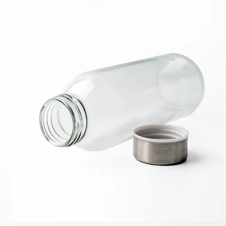 Clear glass bottle displayed with stainless steel cap