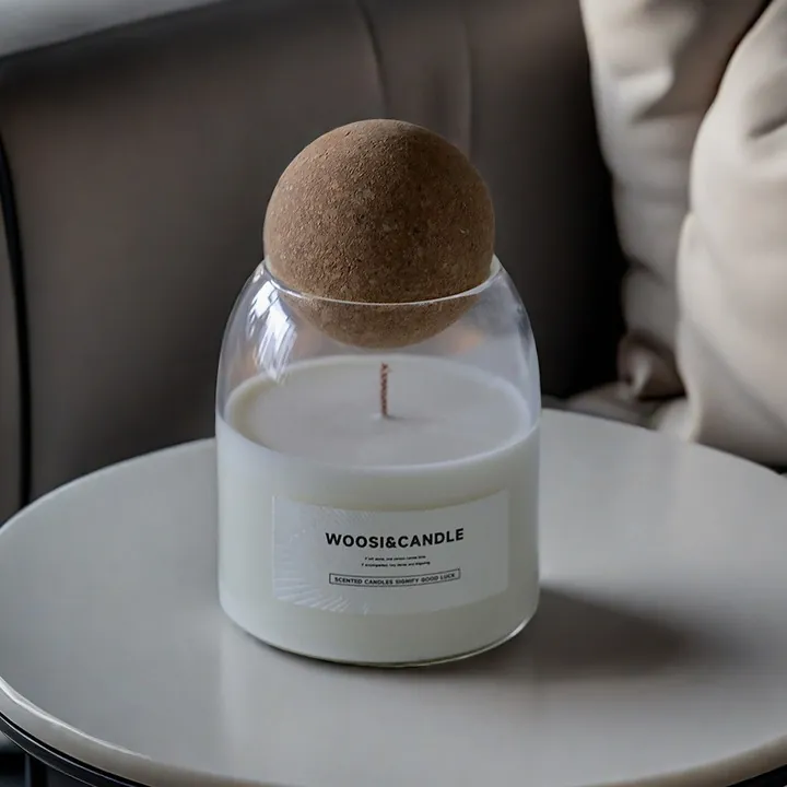 Multiple colored candle jars with lids and branding presentation