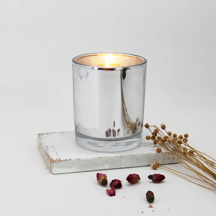Lit candle inside a clear glass candle jar