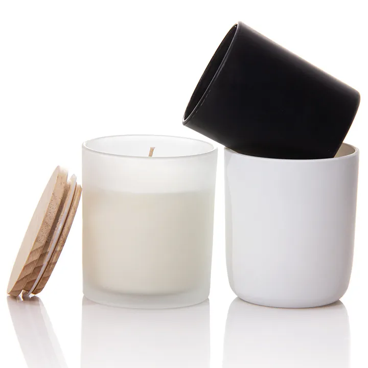 Black and white glass candle jars with wooden lids