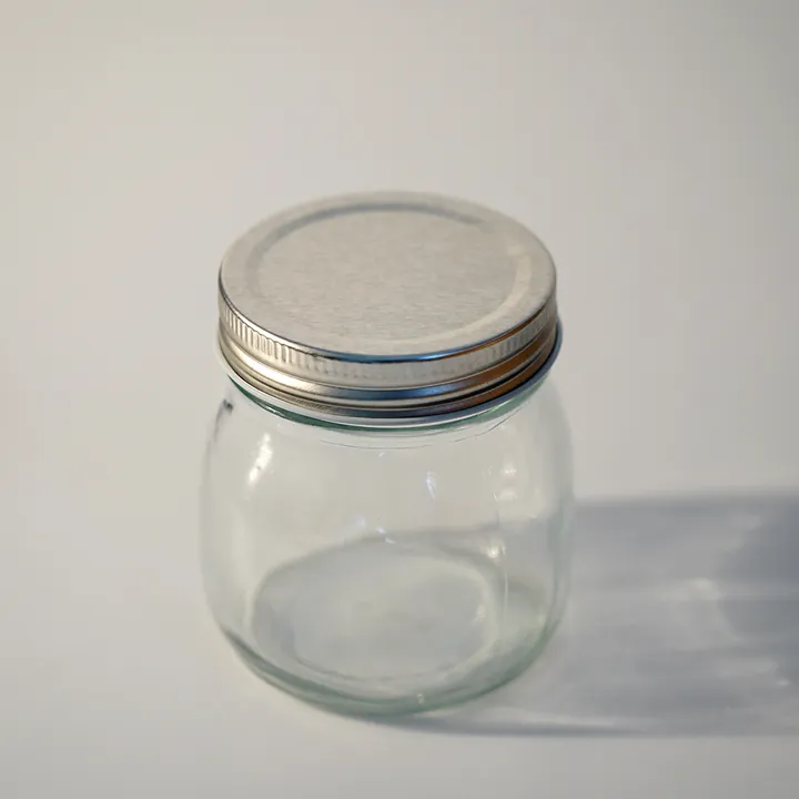 Bocal à bonbons rond en verre avec couvercle en métal argenté