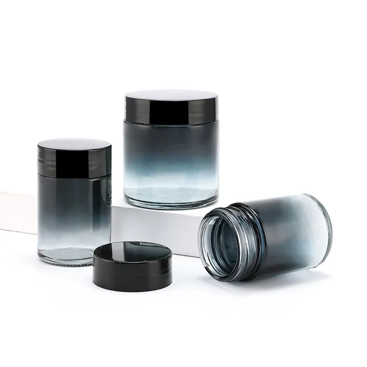 Glass canisters with black lids showing clear, gray, and blue-gray gradient finishes