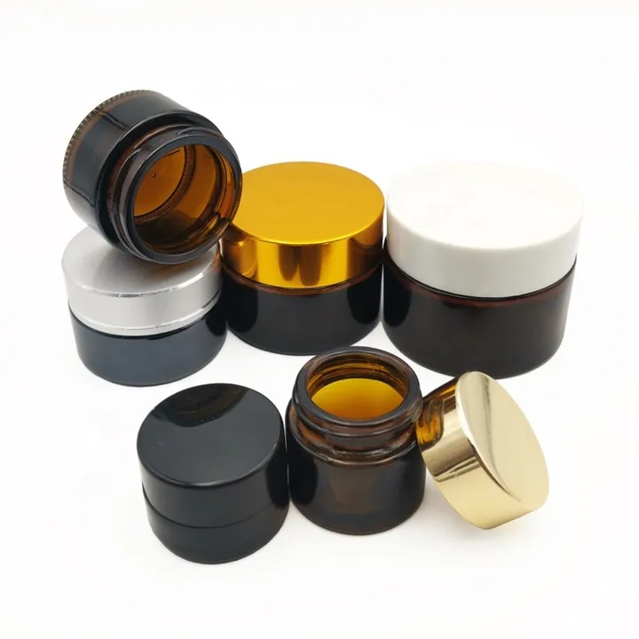 Amber cream jars with black, white, silver and gold caps