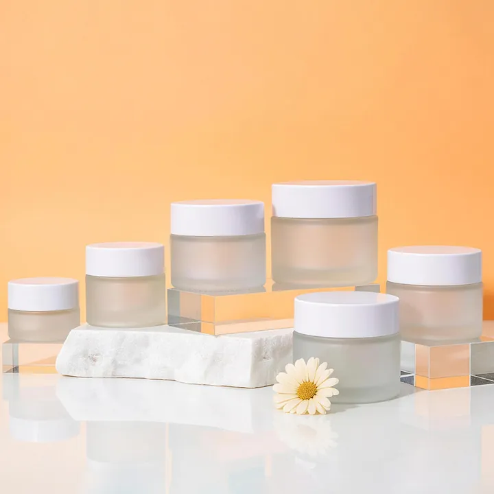 Frosted clear cream jars with white lids