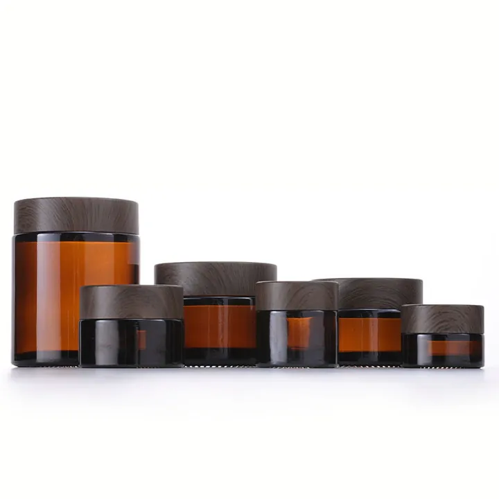 Amber glass cream jars with dark woodgrain lids