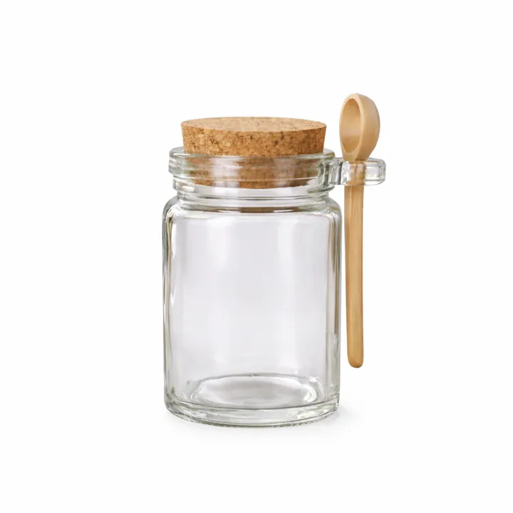 Round glass jar with cork lid and wooden spoon