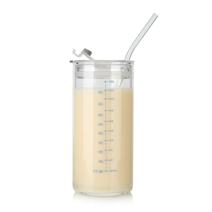 Glass measuring cup with straw and transparent lid
