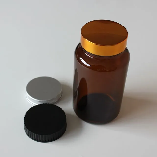 Amber glass pill bottle with gold lid and spare closures
