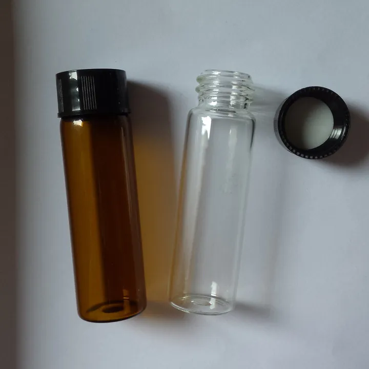 Amber and clear slim glass bottles with black screw caps