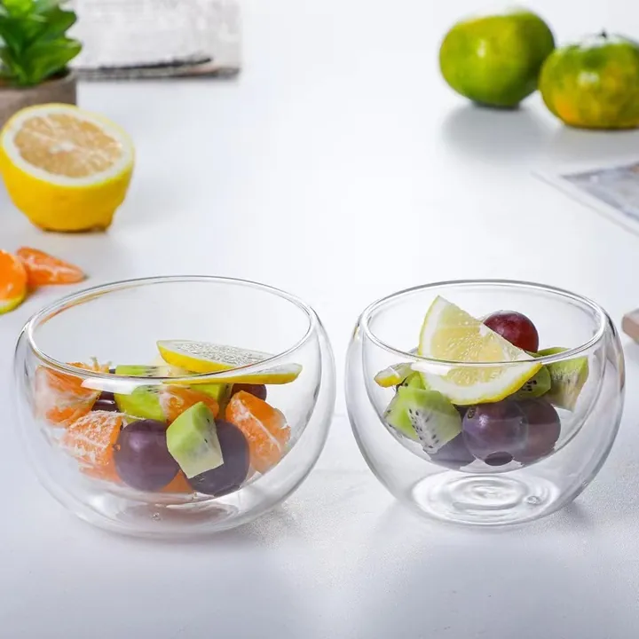 Two double-wall glass bowls filled with fruit