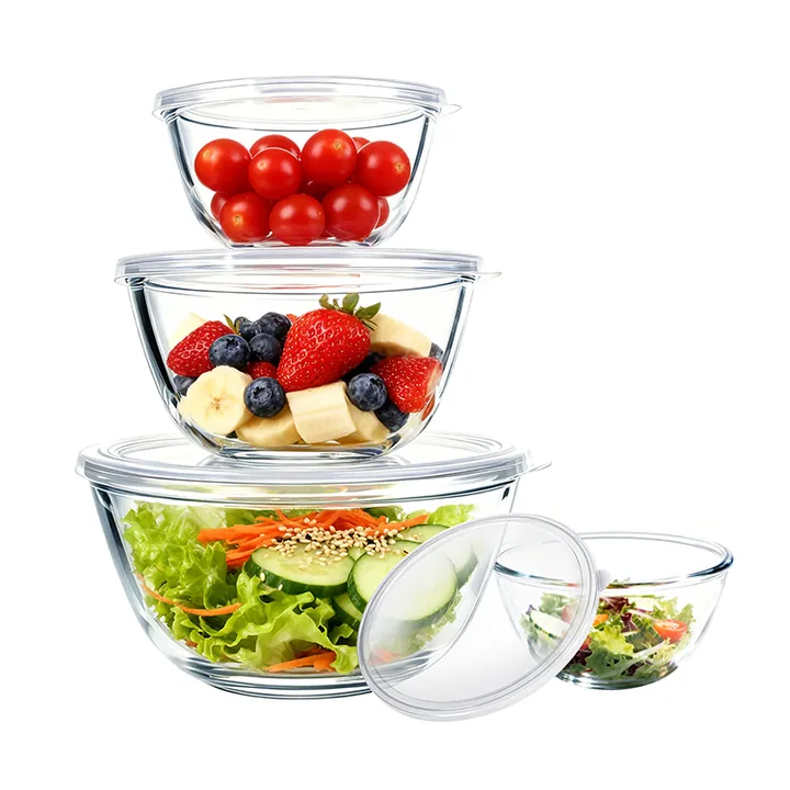Glass salad bowls with lids containing vegetables and fruit