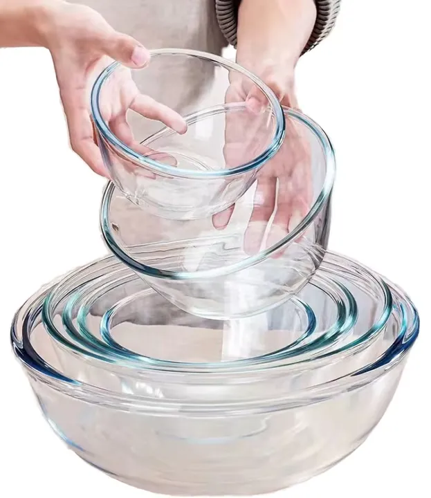 Nested transparent glass bowls with hand removing one bowl