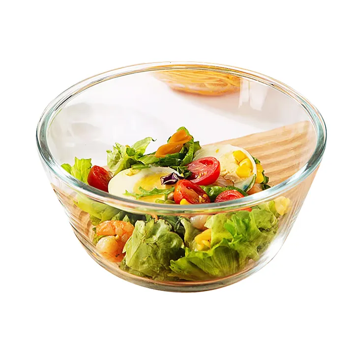 Clear glass salad bowl containing vegetable salad
