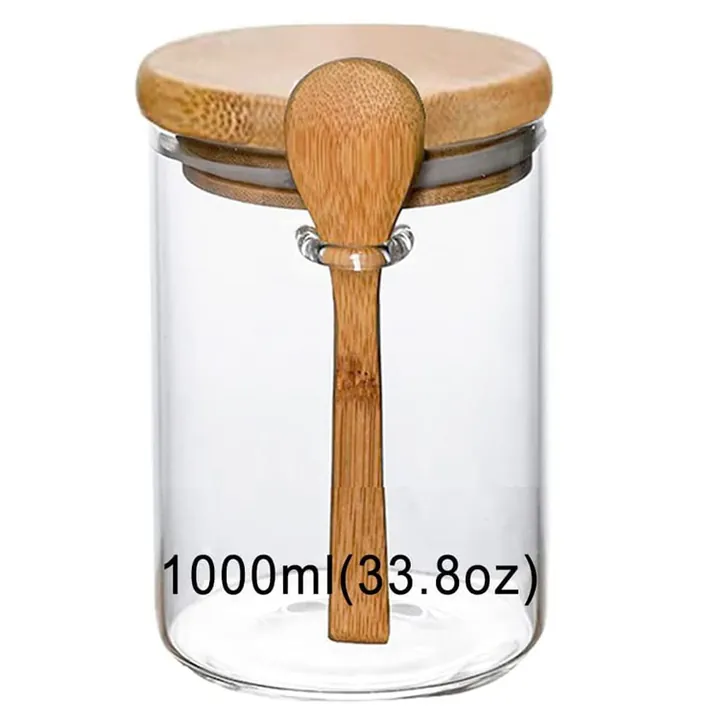 Cylindrical glass spice jar with bamboo lid and bamboo spoon