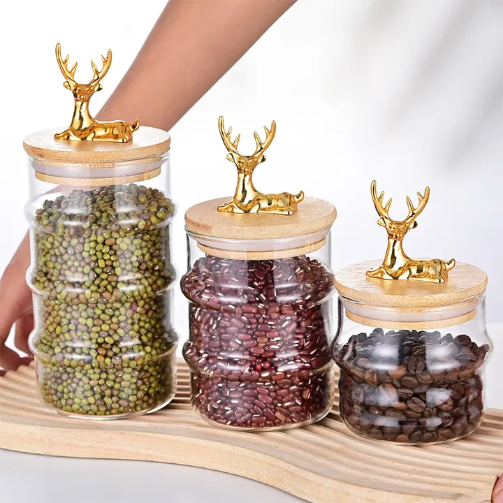 Clear glass storage jars with bamboo lids and gold deer decorations