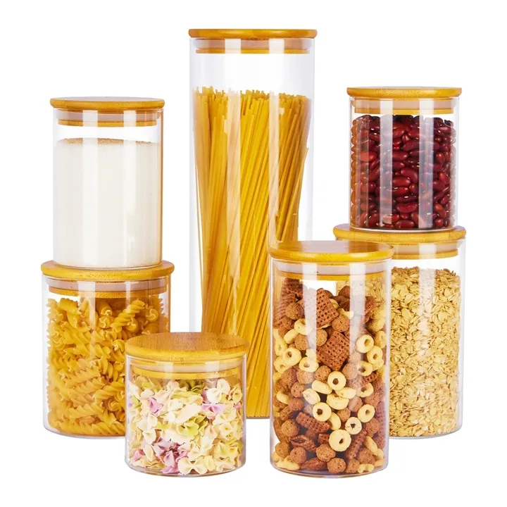 Clear glass storage jars in different capacities with bamboo lids and dry food