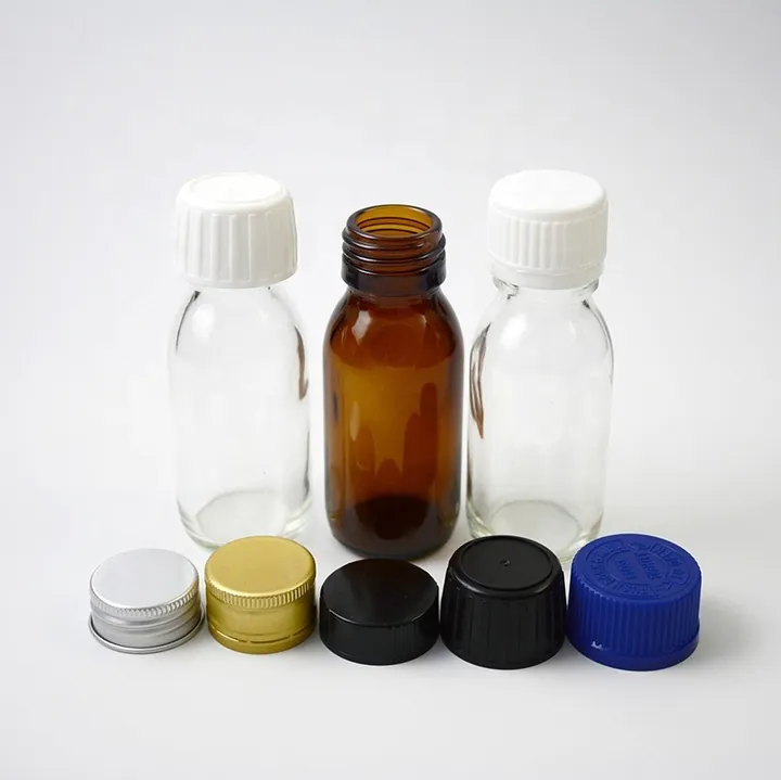 Clear and amber small glass bottles displayed with multiple cap options