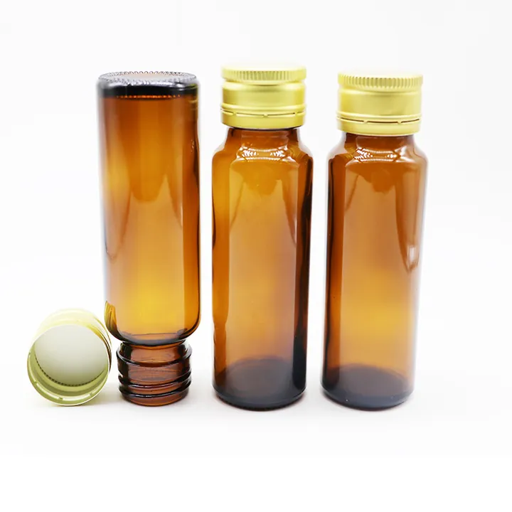 Three slim amber oral liquid glass bottles with gold aluminum caps