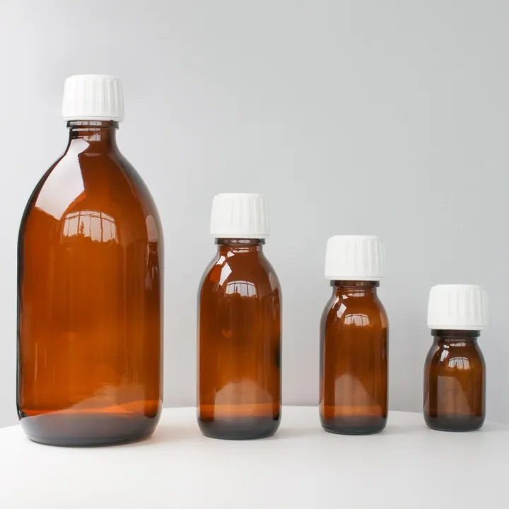 Amber round shoulder syrup bottles in different capacities with white caps