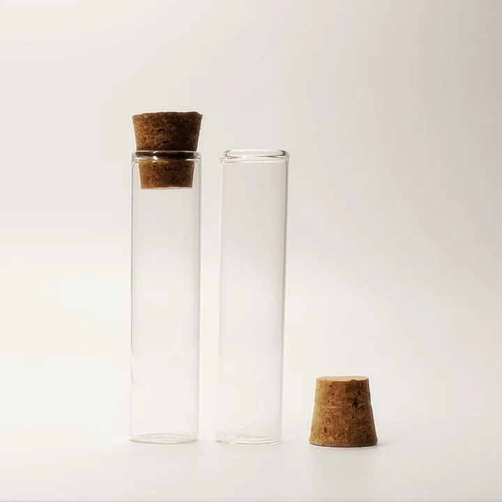 Two transparent flat bottom glass tubes with cork stoppers
