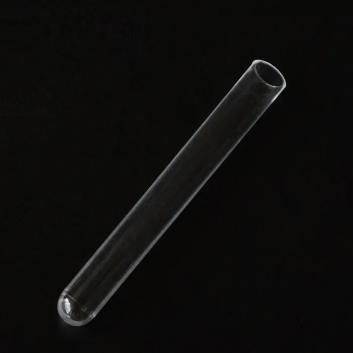 Single transparent round bottom glass tube on a black background