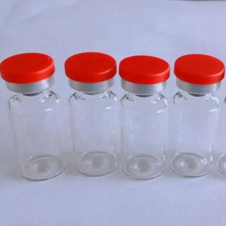 Clear glass vials arranged with red caps