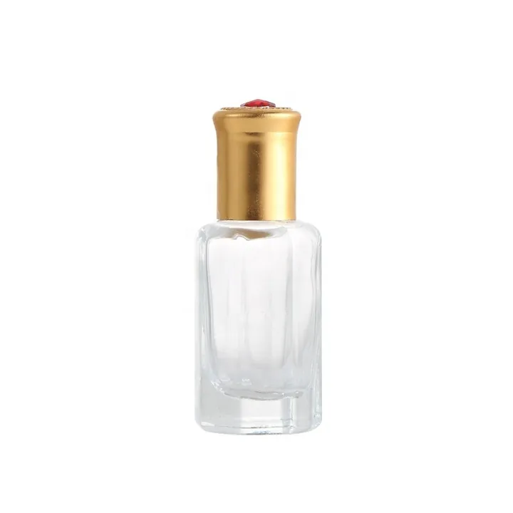 Small clear perfume bottle with gold cap and red top decoration