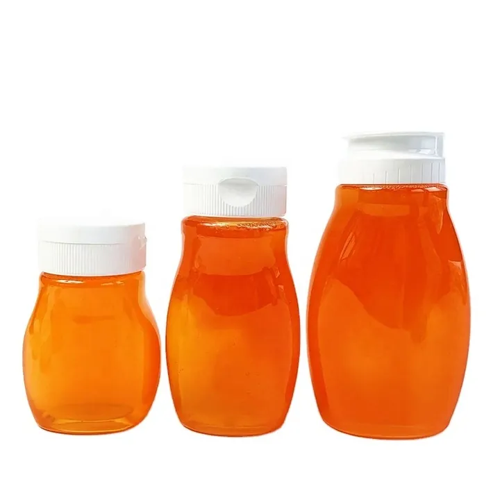Drei durchsichtige Spritzflaschen, gefüllt mit einer orangefarbenen, honigartigen Flüssigkeit
