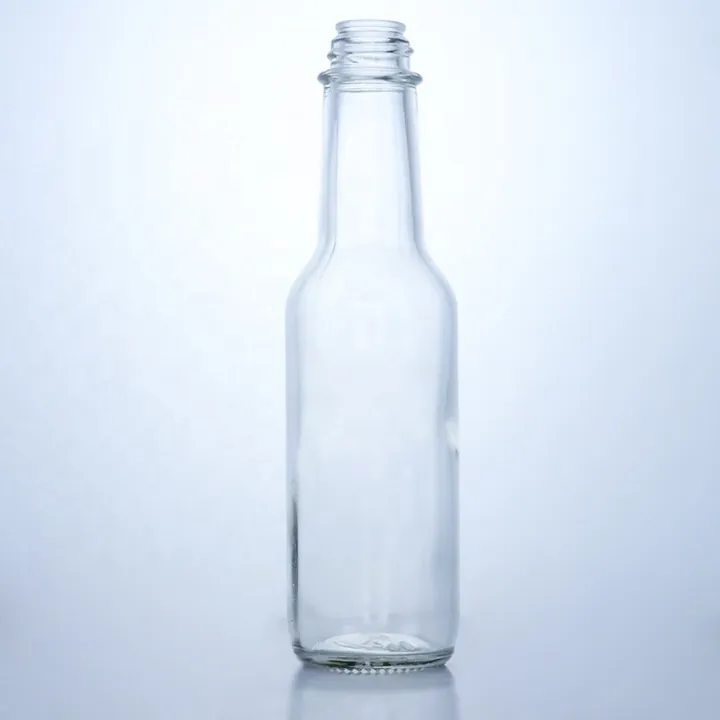 Tall clear hot sauce bottle without cap