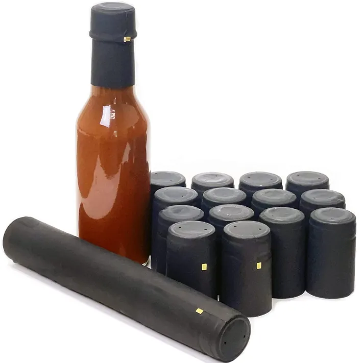 Hot sauce bottle with black shrink caps and sealing strips