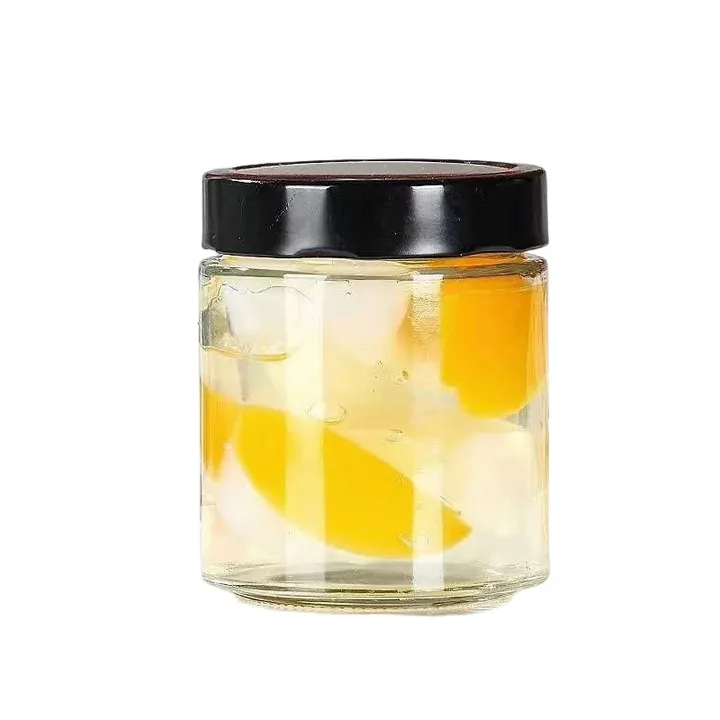 Single glass jam jar filled with fresh fruit