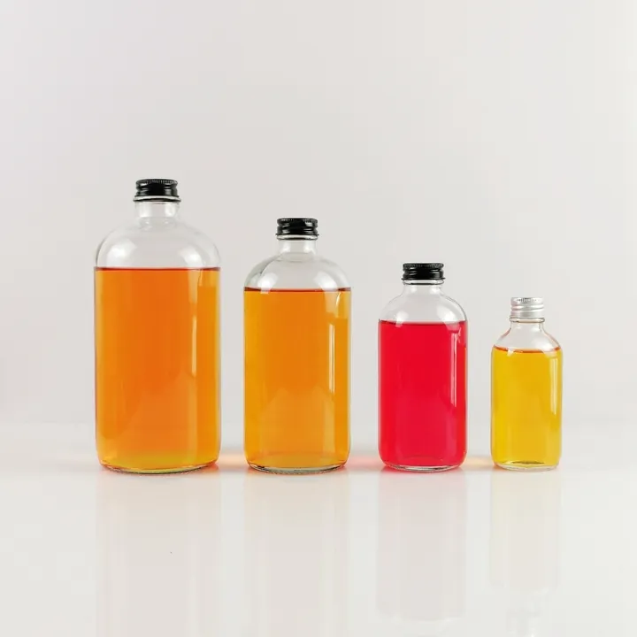Various clear glass bottles filled with colorful drinks