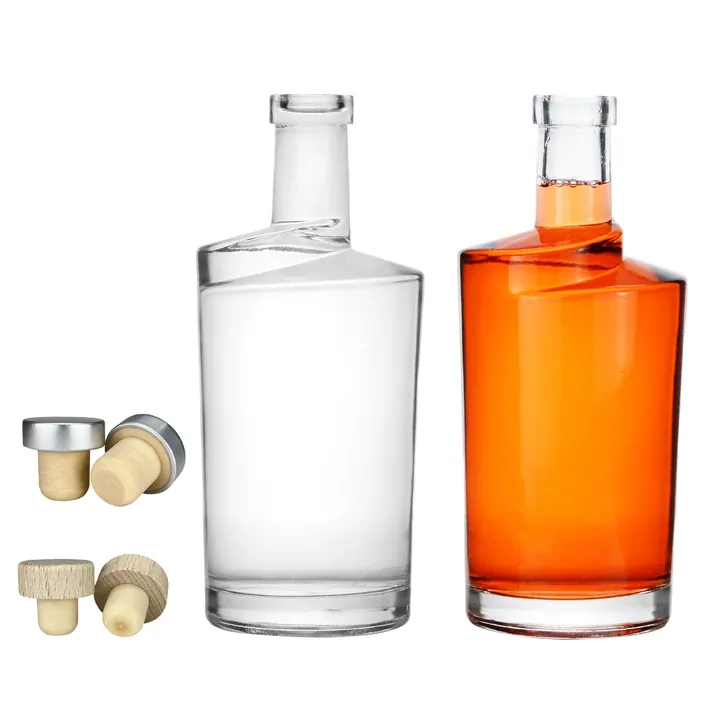 Clear and orange liquor bottles displayed with cork and metal head stoppers