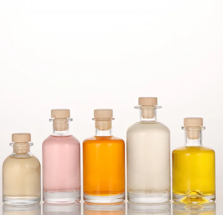 Cinq mini-bouteilles d'alcool de différentes couleurs et contenances, munies de bouchons en liège