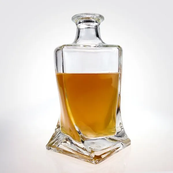 Square twisted liquor bottle filled with amber liquid