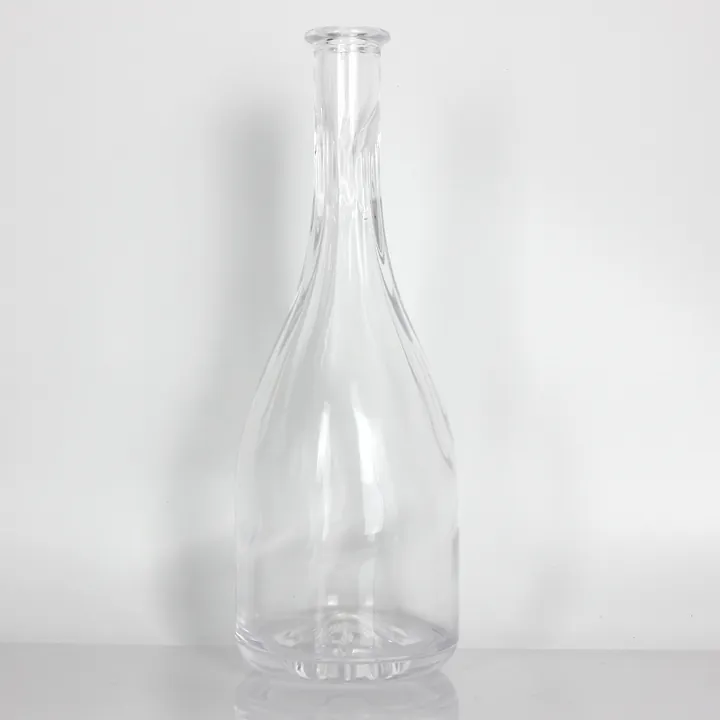 Clear long neck liquor bottle with twisted glass body