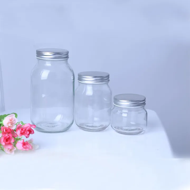 Three clear mason jars in different capacities with silver lids