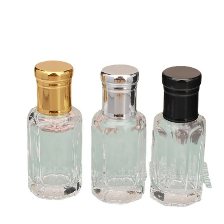 Three clear roll-on perfume bottles with gold silver and black metal caps