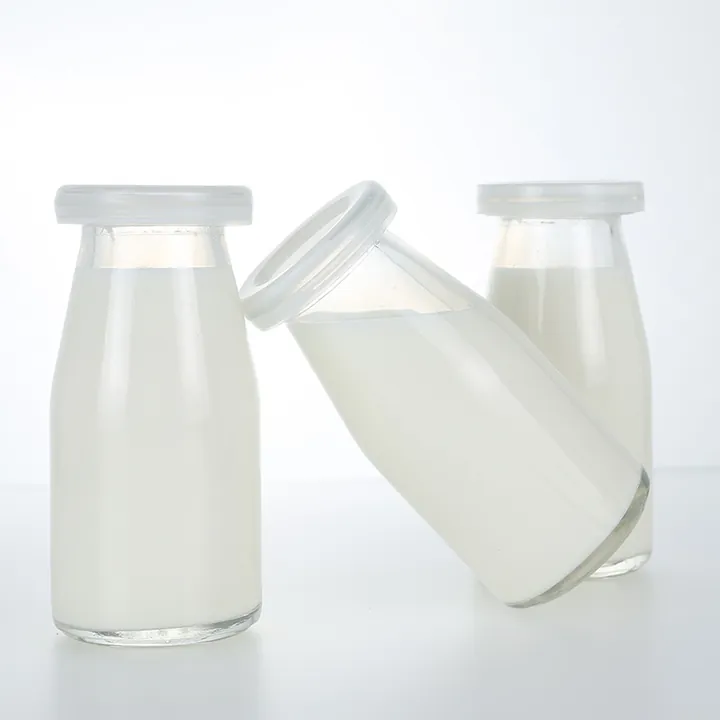 Glass yogurt milk bottles with white plastic caps