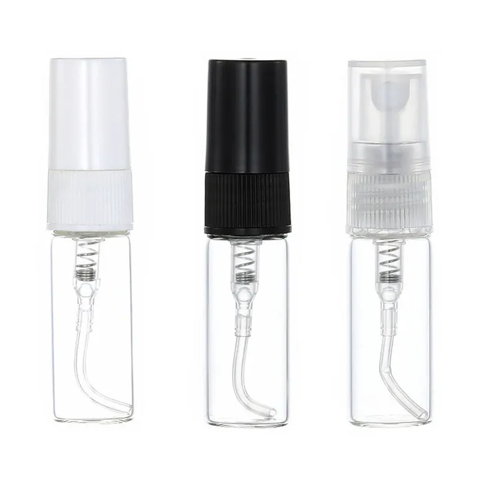 Three small clear perfume sample spray bottles with white black and clear nozzles