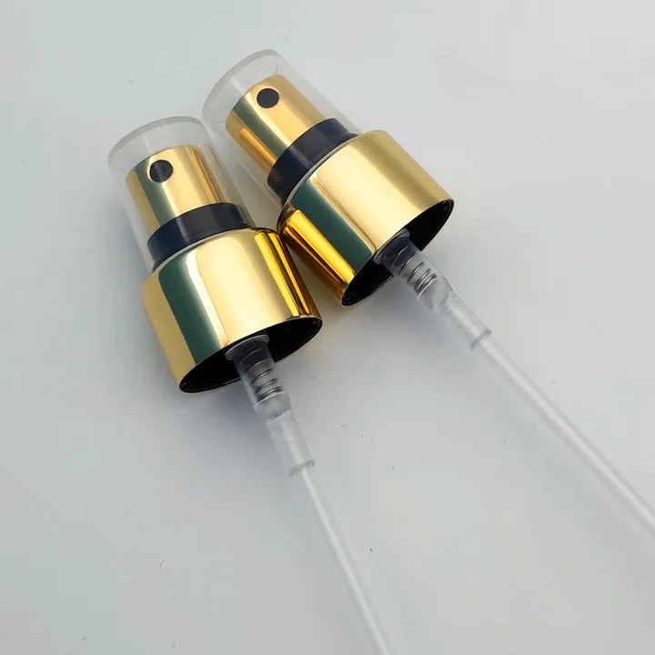 Two gold and black fine mist spray pumps with long dip tubes