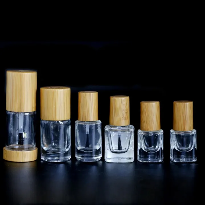 Transparent nail polish bottles with bamboo style caps in different sizes