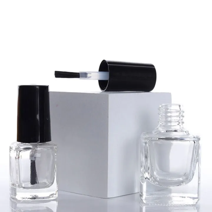 Square nail polish bottle displayed with cap and brush