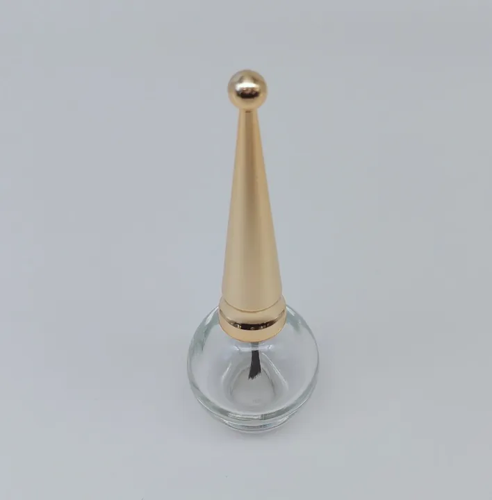 Transparent nail polish bottle with gold cone cap