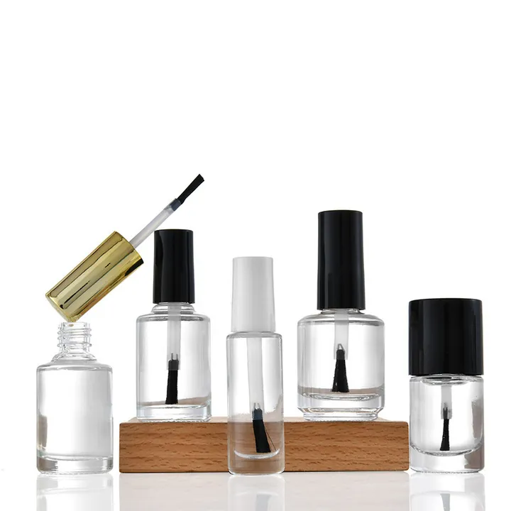 Nail polish bottles in different sizes with black white and gold caps