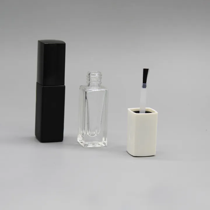 Square transparent nail polish bottle with black cap and brush parts