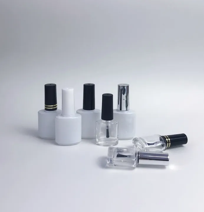 White and transparent nail polish bottles with different cap finishes