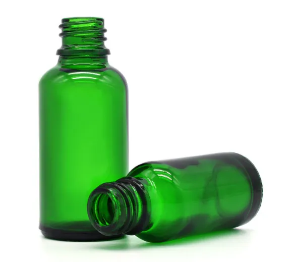 Two green glass bottles displayed opened and closed