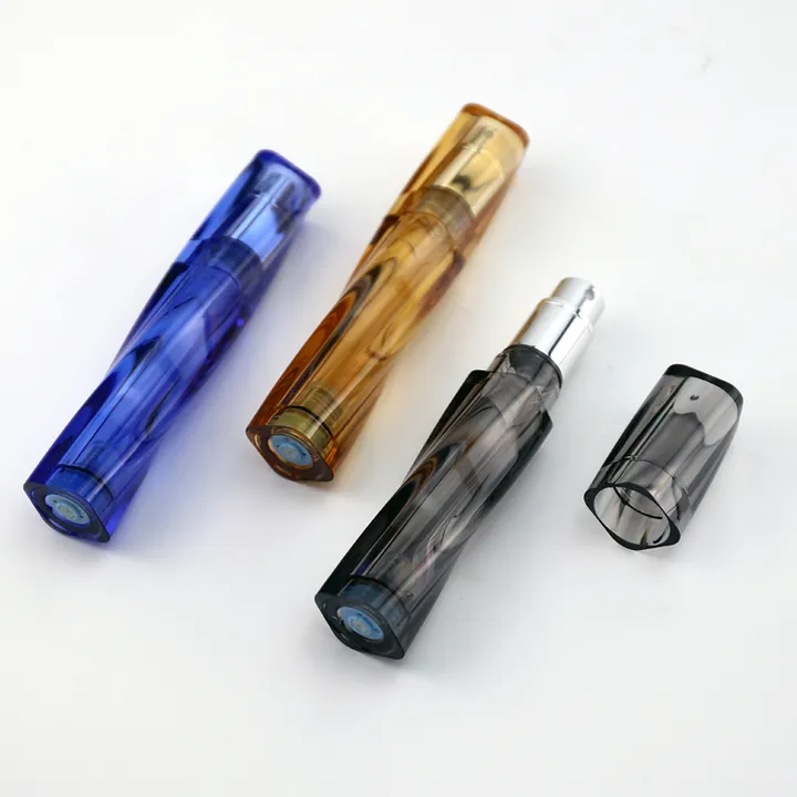 Colorful travel perfume atomizers in blue amber and grey shells